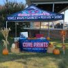 Core Prints fall trade show booths setup with branded canopy, table cover, pumpkins, and hay bale accents.
