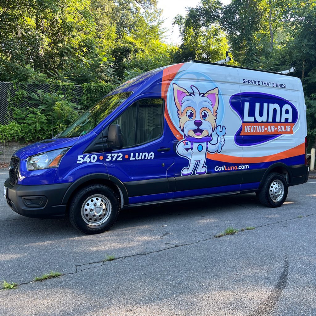 Branded van for Luna Heating, Air, and Solar featuring a blue and orange wrap with a cartoon dog mascot, installed by Core Prints in Fredericksburg, Virginia.