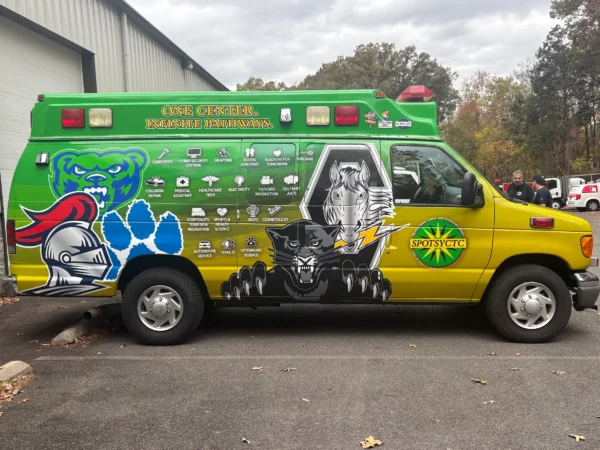 A wrapped passenger van for Spotsy CTC, a vehicle wraps client of Core Prints in Fredericksburg, VA.