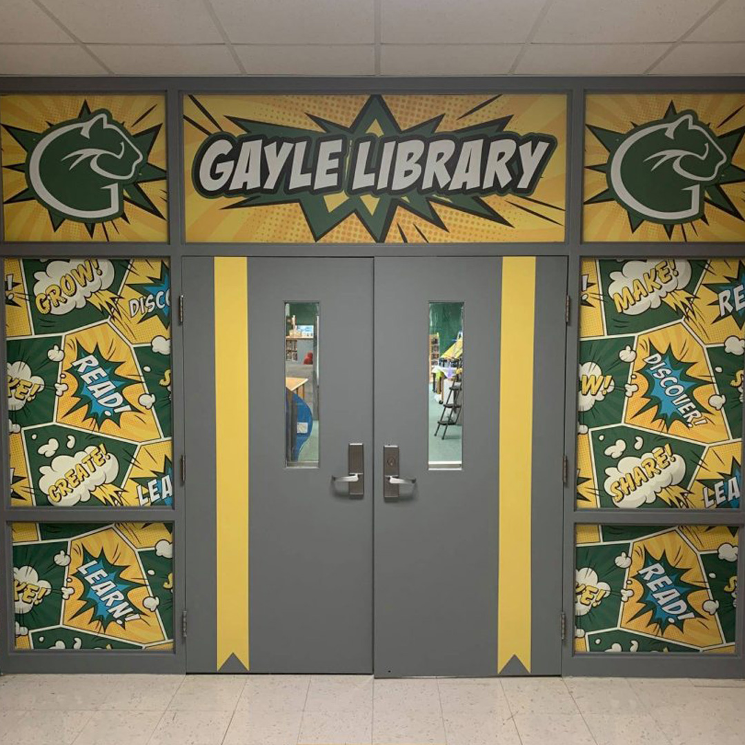 Colorful comic-style wall graphic at the entrance of Gayle Middle School’s library, creating an engaging and inviting reading environment.